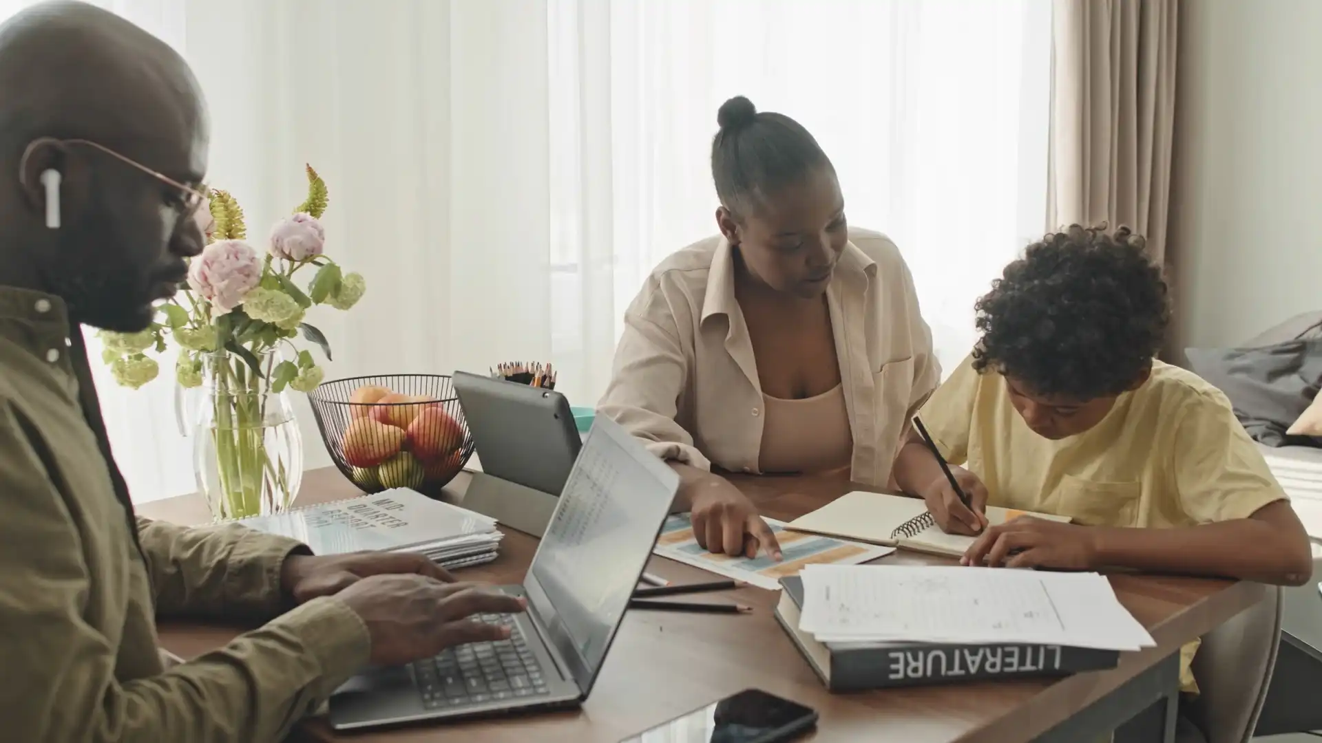 African family engaged in homeschooling - parents teaching their children at home